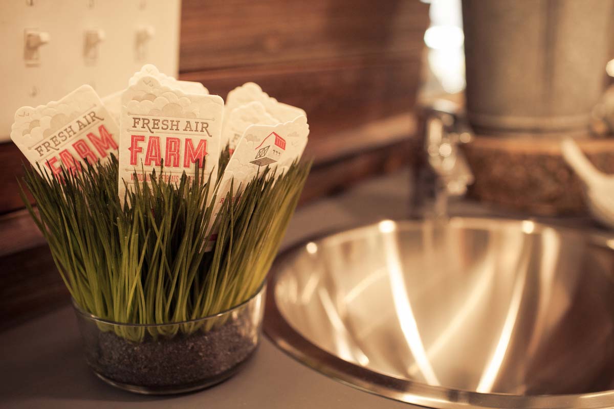 A detail of business cards and sink inside the Airstream trailer at Fresh Air Farm. This trailer functions as a bridal suite for bride's on their wedding day.